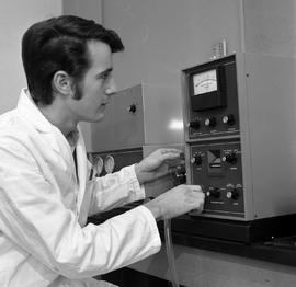 Photograph of a student in the Chemical Technology program working with analysis equipment
