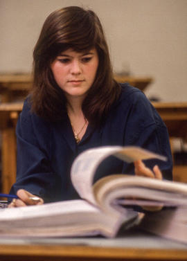 Photograph of a student flipping through a binder