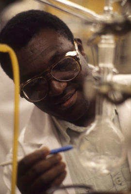 Photograph of a Pharmacy Assistant Student Marking Level On a Container