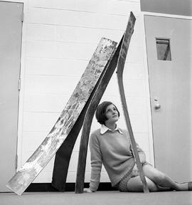 Photograph of Carol Wheten under a metal sculpture