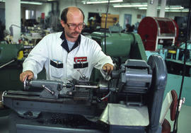 Photograph of an Apprentice Training with a Metal Lathe