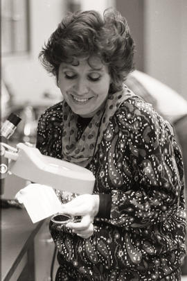 Photograph of a person using a microscope
