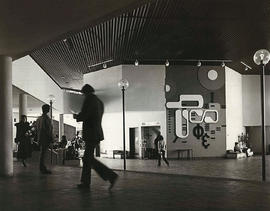 Photograph of the concourse in the E building featuring John Adam's art