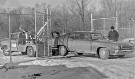 Photograph of a Car Being Towed to a Storage Compound
