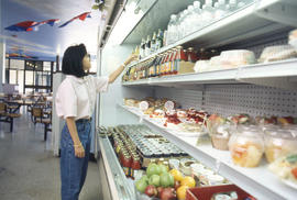 Photograph of a Student Selecting Food at the Kites Cafeteria