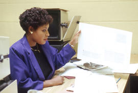 Photograph of a journalism student working with documents