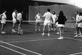 Photograph of a Faculty Member Teaching Students How to Play Tennis