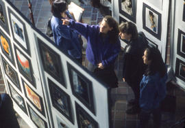 Photograph of people viewing art work in the concourse
