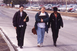 Photograph of students walking along the main roadway in front of J building