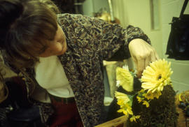 A photograph of a Retail Floriculture student building an arrangement