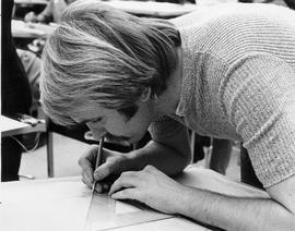 Photograph of a Student Working on a Project on a Drafting Table