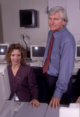 Photograph of two staff members in a computer lab