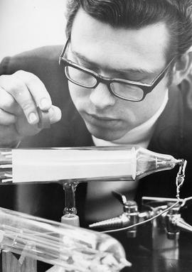 Photograph of a student working with a vacuum tube