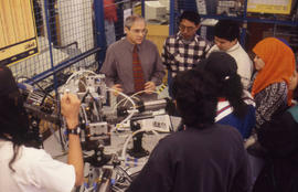 Photograph of faculty member Aurel Bartha with students