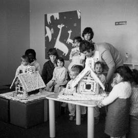 Photograph of Children in the Pediatric Ward Admiring a Gingerbread House