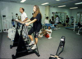 Photograph of student and staff on various fitness equipment