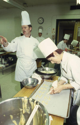 Photograph of Michael McFadden directing students in the kitchen