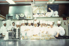 Photograph of Anthony Bevan posing with students for a group pic