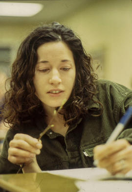A photograph of a Floriculture student examining a twig