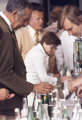 Photograph of Two Staff Members at a Serving Table at a Social Event