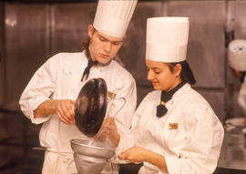 Photograph of two students in the Culinary program cooking together