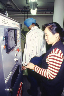 Photograph of students operating a control panel