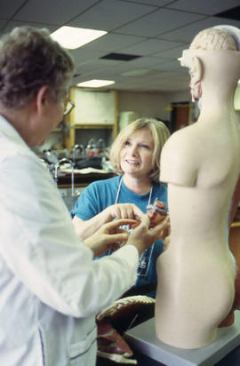 Photograph of Bioscience faculty member working with a student in the lab.