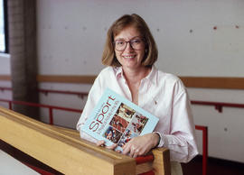 Photograph of Jill LeClair holding a book