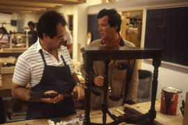 Photograph of students working in a furniture refinishing program
