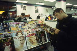 A photograph of a student reading a magazine in the Bookstore