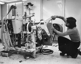 Photograph of a Student Maintaining Packaging Equipment