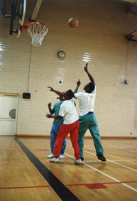 Photograph of students playing a game of pick-up basketball