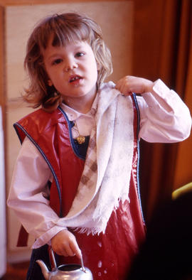 Photograph of a child in an apron