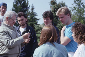 Photograph of an instructor lecturing outside