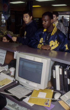 Photograph of students at the service desk in residence