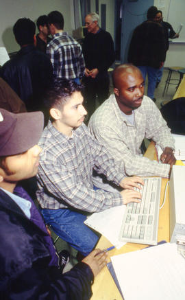 Photograph of students working on assignments at the computer
