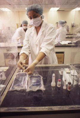 Photograph of a Pharmacy Assistant Student Preparing a Saline IV Bag
