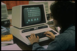 Photograph of a student playing a game on a Commodore Pet