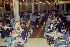 A photograph of seated students and staff lunching in the Pipe cafeteria