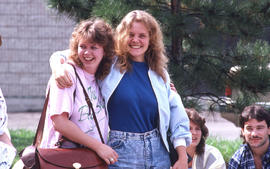 Photograph of two persons hugging and smiling