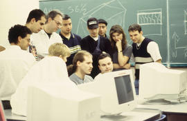 Photograph of students gathered around the computer