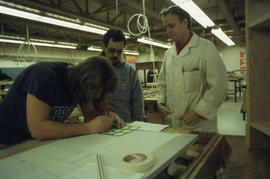 Photograph of faculty member Mark Paddison and students in the woodwork lab