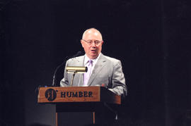 Item 1 - Photograph of John Davies at the podium speaking at the HAMS opening