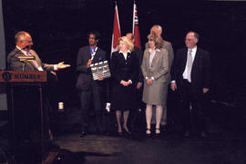 Item 2 - Photograph of John Davies along with a group on the stage at the HAMS opening
