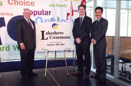 Item 4 - Photograph of John Davies and two staff members next to the opening banner