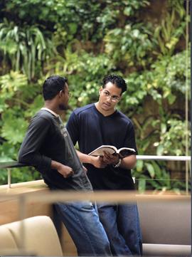 Photograph of two students in front of the Living Wall